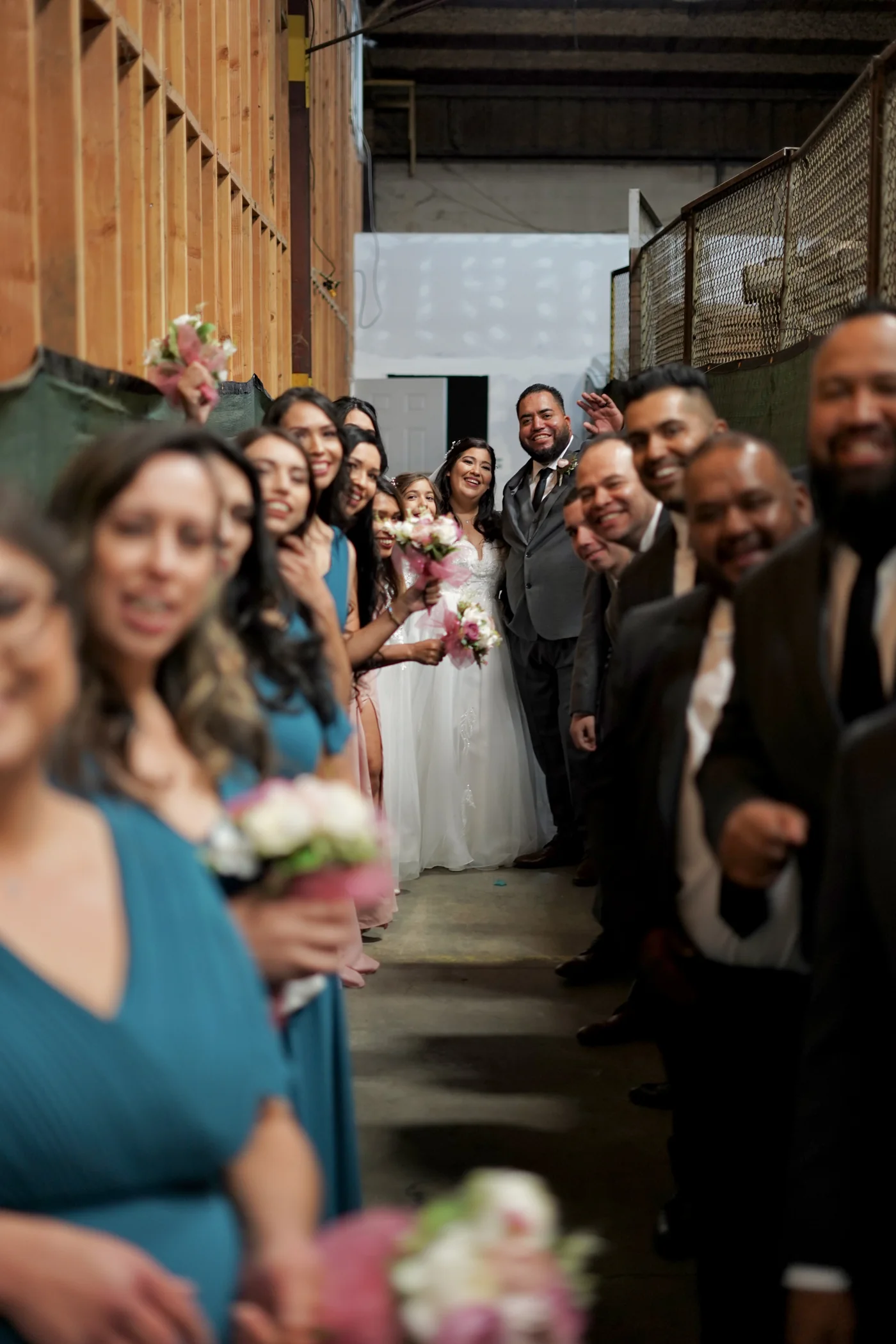 Newlyweds walking down the aisle between smiling guests