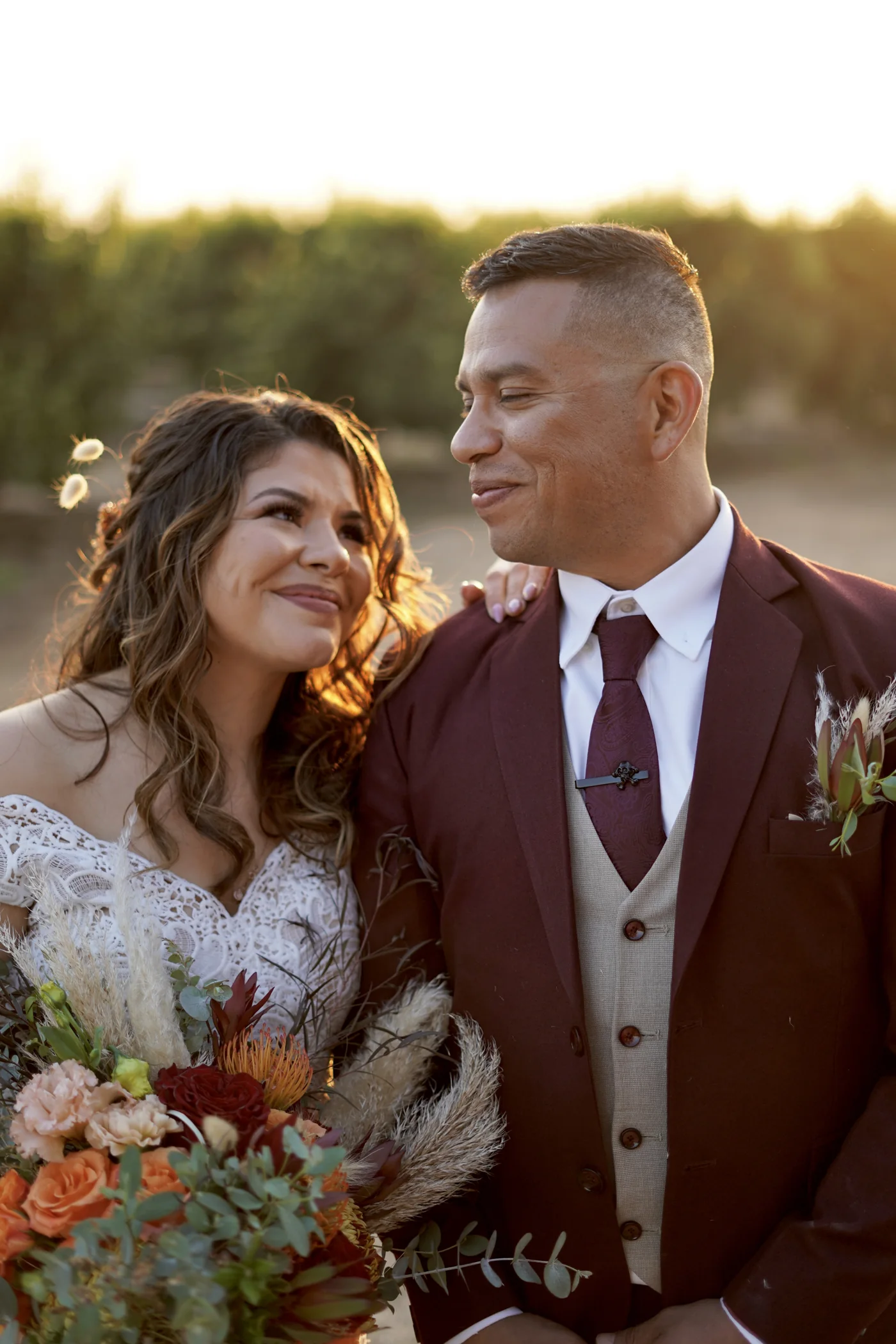 A newlywed couple together in warm evening light
