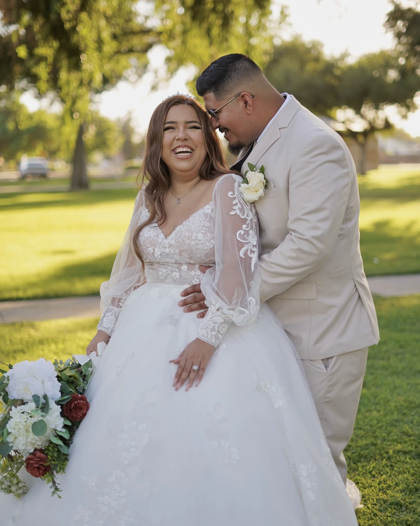 A bride laughing as the groom leans close